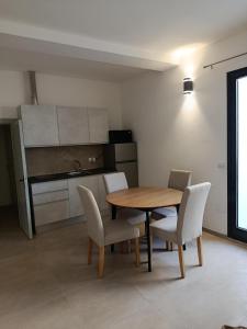 a kitchen and dining room with a table and chairs at Via Roma 50 in Bacu Abis