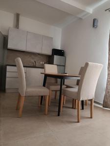 a dining room with a table and two chairs at Via Roma 50 in Bacu Abis