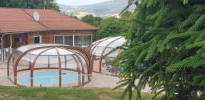 two gazebos in a yard with a pool at 5 Chalet Iris in Blavignac
