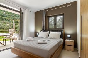 a bedroom with a bed with two towels on it at Sokol stone house in Vlikhón