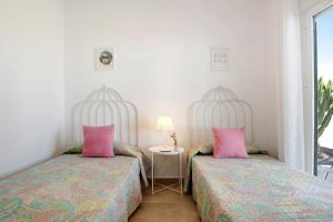 two beds sitting next to each other in a room at La Casita de la Florida in Conil de la Frontera +19 photos