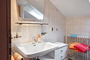 a bathroom with a sink and a mirror at Haus Palais in Münstertal +20 photos
