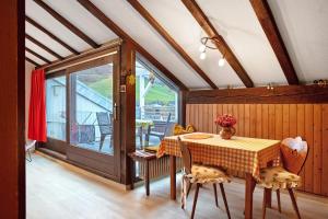 a dining room with a table and a balcony at Haus Palais in Münstertal