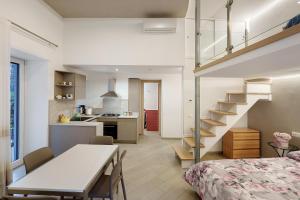 a bedroom and a kitchen with a staircase in a room at Casa Imperati in Agerola