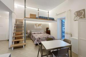 a bedroom with a bed and a table and a desk at Casa Imperati in Agerola