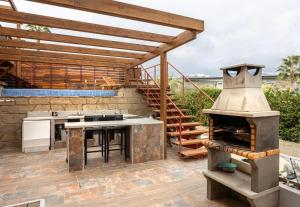 a outdoor kitchen with an oven and a grill at Luxury 3 Beds Villa Inside Resort in Estepona