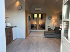 a living room with a couch and a table at Mountain View Apartment at Rauðafell in Hvolsvöllur
