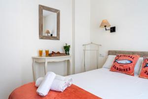 a bedroom with a white bed with a mirror and a mirror at Apartamento Sf2 in L'Ametlla de Mar