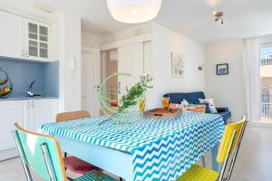 a dining room with a blue and white table and chairs at Apartamento Sf2 in L'Ametlla de Mar +20 photos