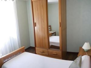a bedroom with two beds and a mirror at Gite La Lavande in Peyreleau +7 photos