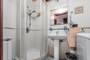 a bathroom with a shower and a sink at Red House Capoterra in Capoterra +13 photos