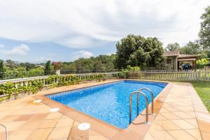 a swimming pool in a yard with a fence at Casa La Granja in Olvan