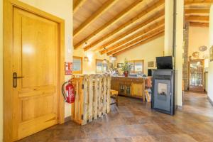 a room with a wooden door and a stove at Casa La Granja in Olvan