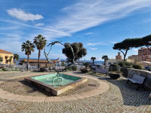 a fountain with a bird statue in a park at Casa Veronica Rio Marina in Rio Marina