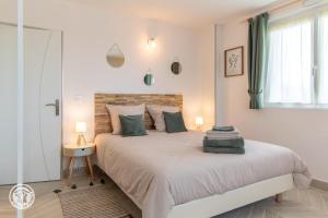 a bedroom with a large bed and a window at Notre Petit Paradis in Annecy