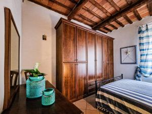 a bedroom with a bed and a wooden cabinet at Casa Veronica Rio Marina in Rio Marina