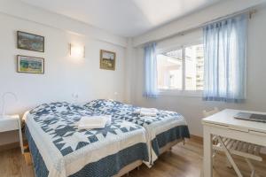 a bedroom with a bed and a desk and a laptop at Apartment Acapulco in Fuengirola +15 photos