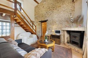 a living room with a couch and a fireplace at Gîte des Fraignaies in Saint-Juire-Champgillon