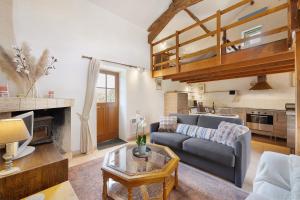 a living room with a couch and a table at Gîte des Fraignaies in Saint-Juire-Champgillon