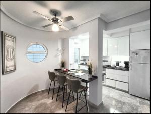 a kitchen with a table with chairs and a ceiling fan at R-15 Large Holiday House in Torrevieja
