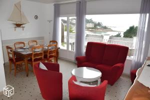a living room with a table and chairs and a dining room at Maison Gwel Kaer in Perros-Guirec