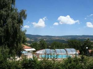 a swimming pool with a domed building next to at 16 Chalet Hibiscus in Blavignac