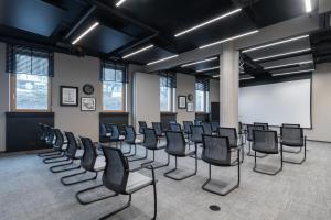 a room with a bunch of chairs in it at HARBR Hotel Ludwigsburg, a member of Radisson Individuals in Ludwigsburg