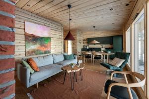 a living room with a couch and a table at Aurora Atelier Onnela in Rovaniemi +15 photos
