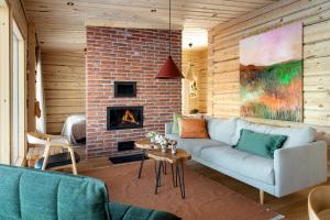 a living room with a couch and a fireplace at Aurora Atelier Onnela in Rovaniemi