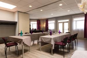 a conference room with tables and chairs with purple candles at Relais St Eloi, Sure Hotel Collection by Best Western in Tours