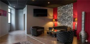 a living room with two chairs and a table at Relais St Eloi, Sure Hotel Collection by Best Western in Tours