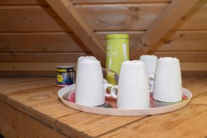 a tray of cups on a wooden table at Kota Crème Catalane in Saint-André