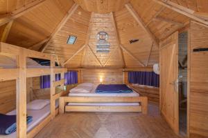 a bedroom with two bunk beds in a wooden cabin at Kota Crème Catalane in Saint-André