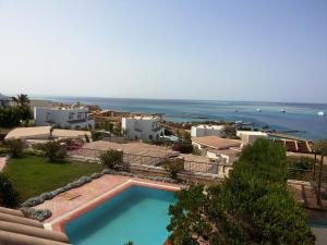 a view of a resort with a swimming pool and the ocean at Hurghada Beach House in Hurghada