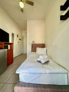 a bedroom with a bed with towels on it at Petit City in Orestiada