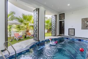 a swimming pool with a swan in a house at Aara-boutique stay udaipur in Udaipur