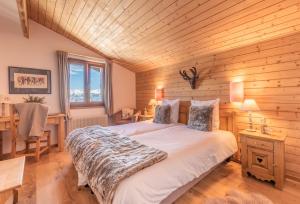 a bedroom with a bed and a wooden wall at Victoria Retreat & Spa in Vercorin