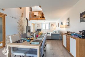 a kitchen and living room with a long table at Notre Petit Paradis in Annecy