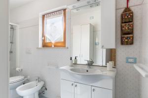 a bathroom with a sink and a toilet and a mirror at Baita Bocheto in Levico Terme +25 photos