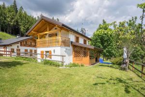 a house on a hill with a fence at Baita Bocheto in Levico Terme