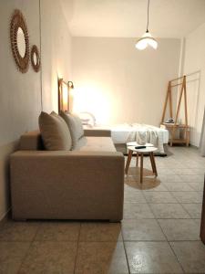 a living room with a couch and a bed at Afytos Sivilla in Afitos