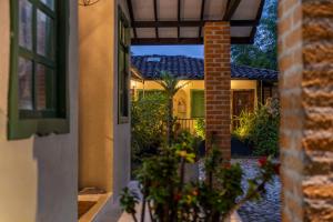 an entrance to a house with a brick pillar at Tukki Ecolodge Hotel in Filandia