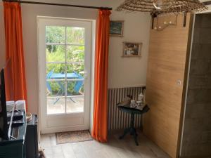 a room with a door and a table and a patio at Chambre D'hôtes - Chambre in Jeufosse