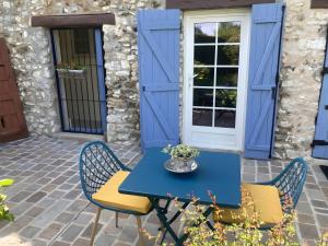 a blue table and chairs in front of a house at Chambre D'hôtes - Chambre in Jeufosse +7 photos
