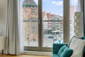 a room with a window with a view of a city at Waterlane Riverside - SPA, Pool, Gym & Parking by Downtown Apartments in Gdańsk