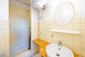 a bathroom with a sink and a shower at Les Mimosas - Appartement 09 in Cazaubon +12 photos