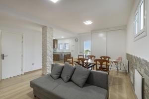 a living room with a couch and a dining room at Teror Hills in Teror