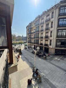 a group of people sitting outside of a building at Apartamento Villarias in Bilbao