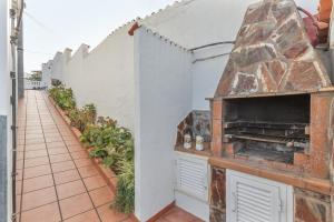 an outdoor kitchen with a stone oven in a building at Teror Hills in Teror