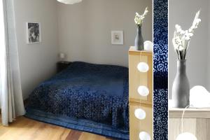 a bedroom with a bed with a blue comforter at Les Hauts De Font Moure in Saint-Georges-des-Agoûts